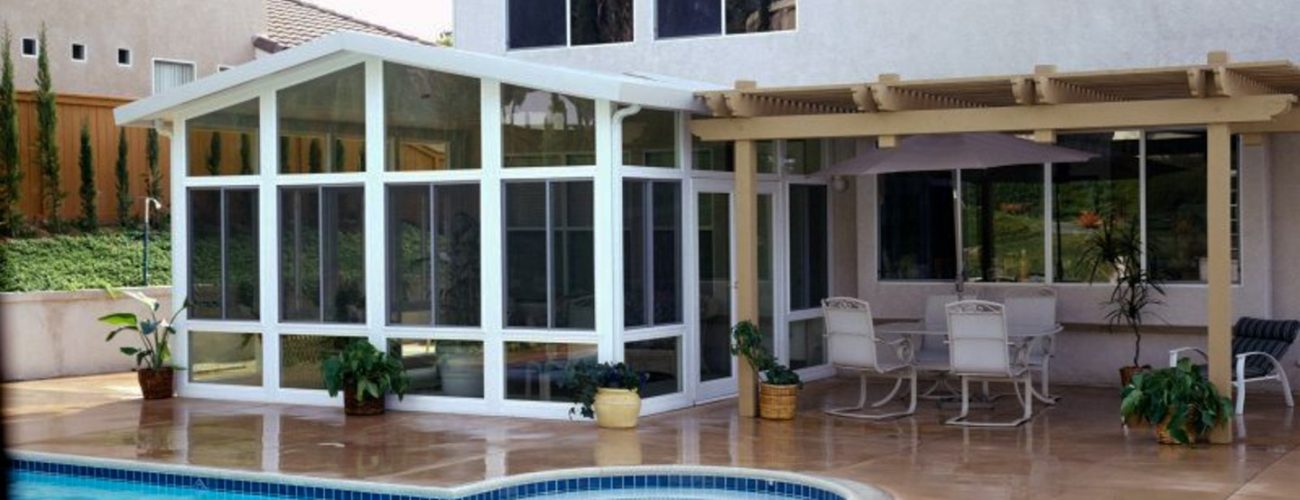 sunroom enclosures by a relaxing oasis pool